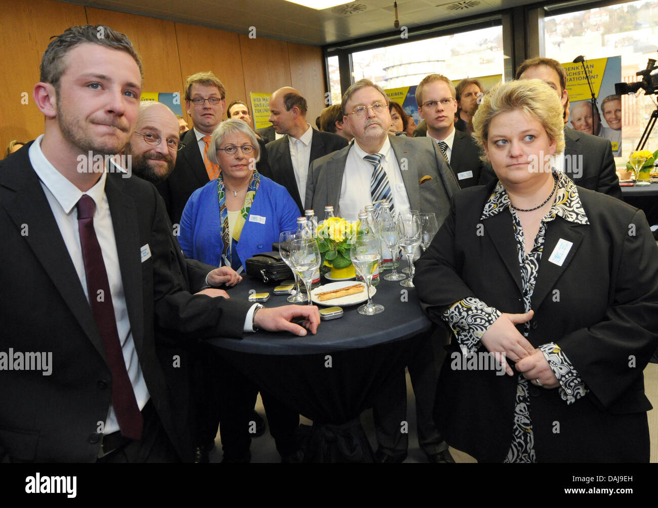 FDP party members look at the first election forecast during the Baden