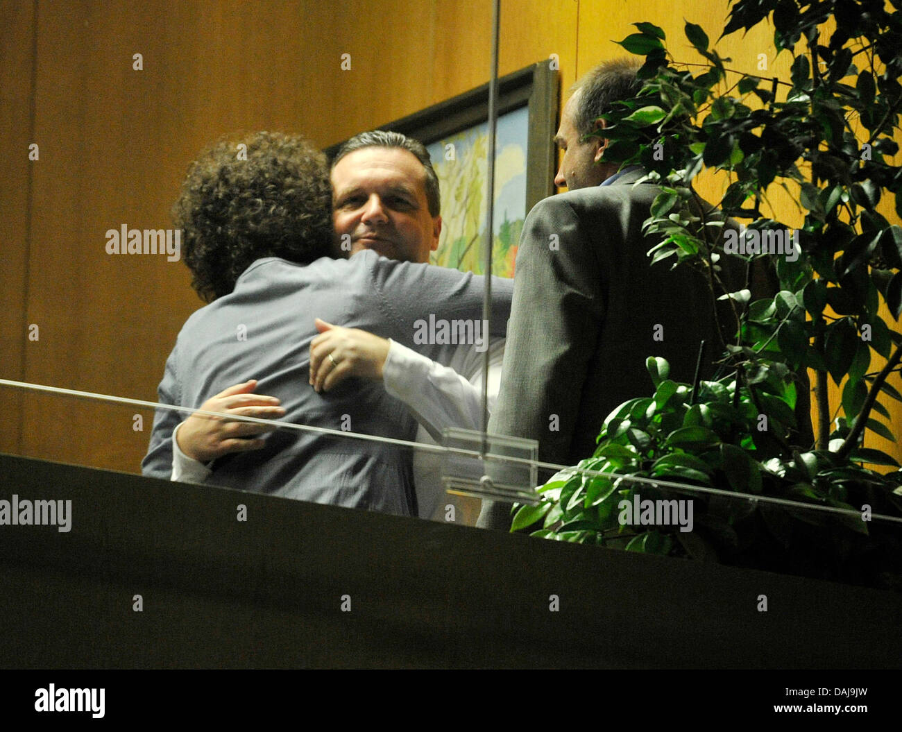 A woman embraces the Premier of  Baden-Württemberg Stefan Mappus (CDU) in his office at Baden-Wuerttemberg's state parliament in Stuttgart, Germany, 27 March 2011. The CDU had to accept a bitter defeat in the 2011 Baden-Wuerttemberg state elections. Photo: Boris Roessler Stock Photo