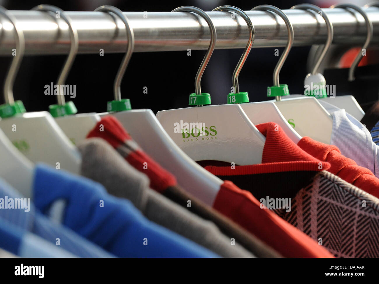 Clothes hang on hangers featuring the logo of Hugo Bossfashion company in  Metzingen, Germany, 29 March 2011. The same day, Hugo Boss reports a plus  of eleven per cent in turnover to