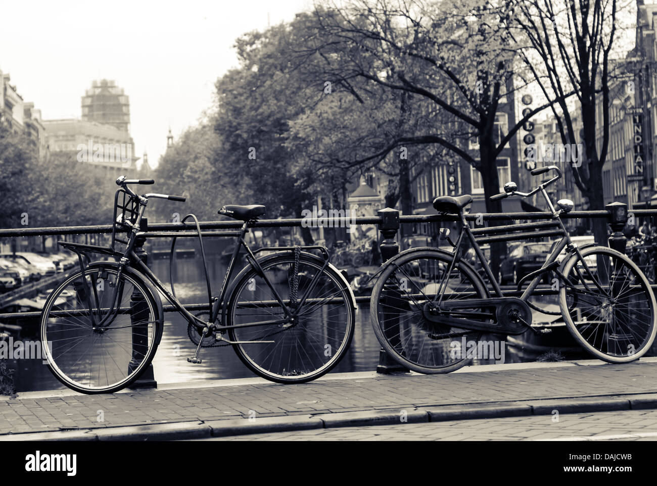 Bicycles against a bridge in Amsterdam, Monochrome Stock Photo