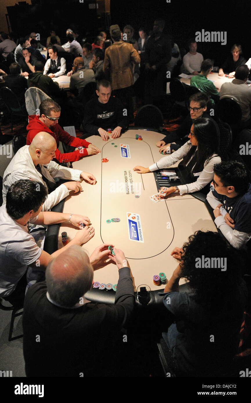Poker players and dealers sit at poker tables inside the Berlin casino  during the Berlin poker tournament of the European Poker Tour (EPT) in  Berlin, Germany, 5 April 2011. The tournament with