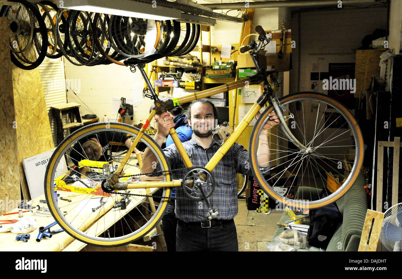 Project manager Thomas Finger of the Berlin Institute of Technology  presents a bicycle made of bamboo in Berlin, Germany, 25 March 2011. A  frame made of bamboo, wooden rims and mudguards made