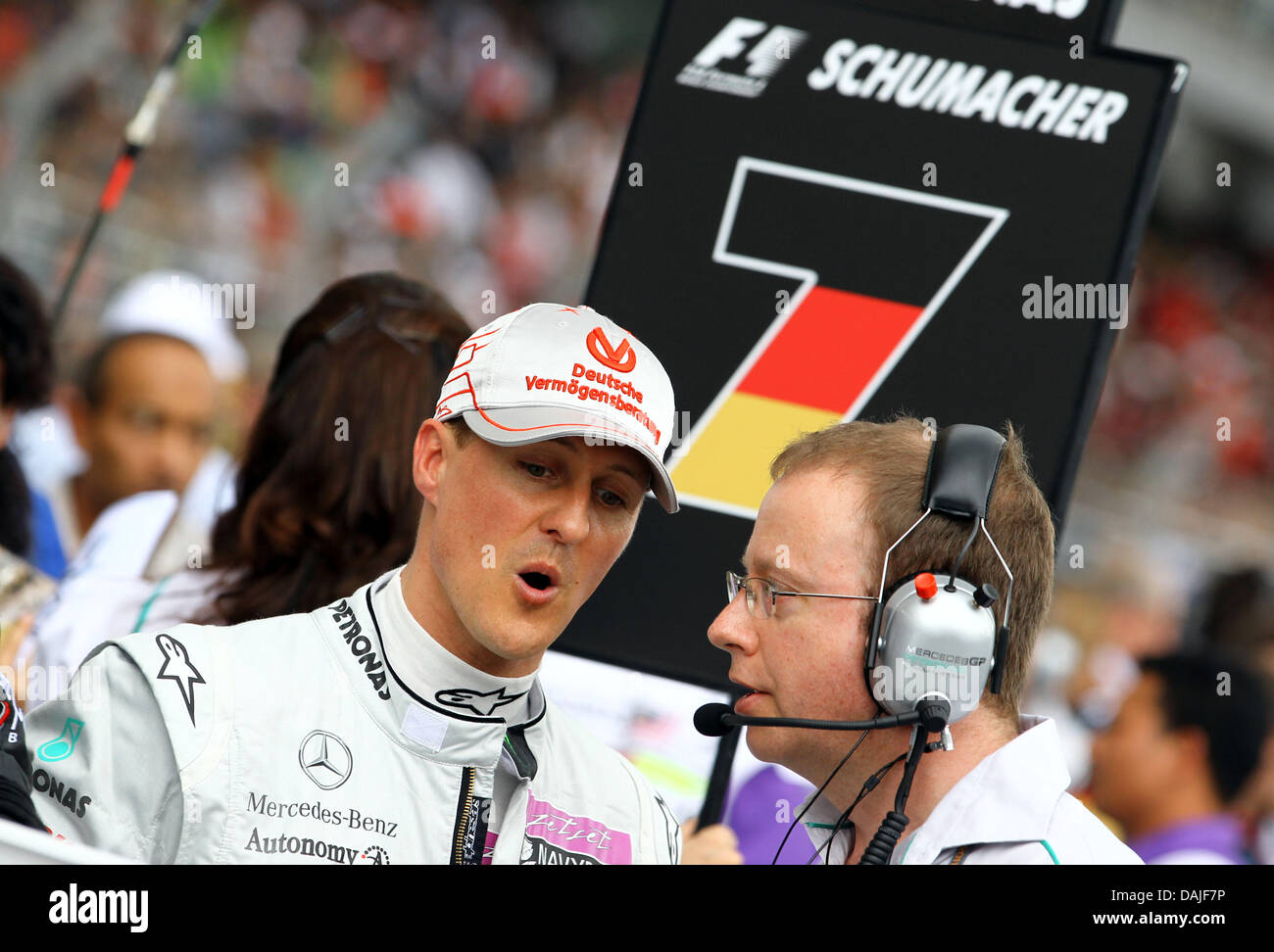 German Formula One driver Michael Schumacher (L) of Mercedes GP talks