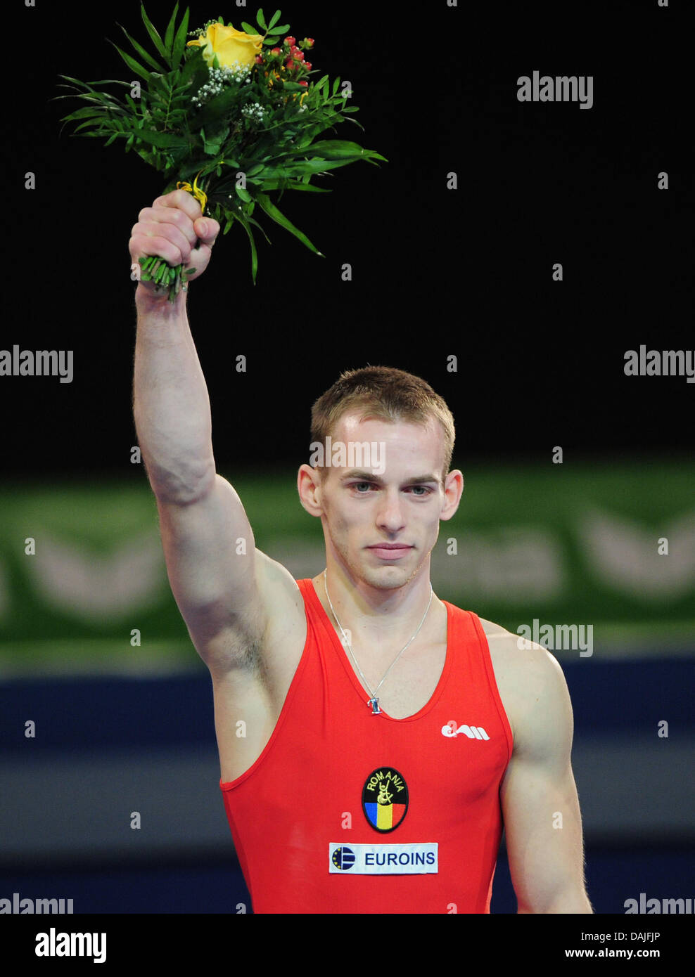 Romanian athlete Flavius Koczi cheers during the award ceremony after