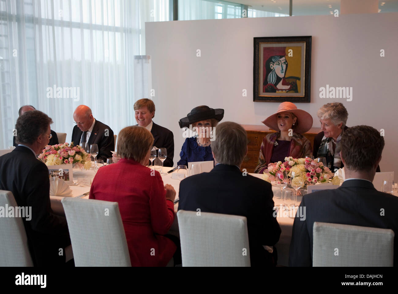 Chancellor Angela Merkel (in front, red) speaks to Queen Beatrix of The Netherlands (C), Crown Prince Willem-Alexander (L) and Crown Princess Maxima  (R) in  the Chancellory in Berlin, Germany, 12 April 2011. Chancellor Merkel meets the Royal Family for lunch. PHOTO: MICHAEL KAPPELER Stock Photo