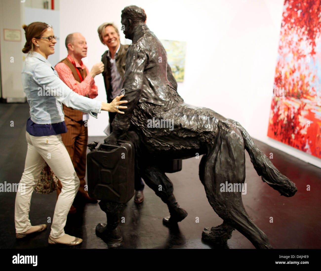 Visitors  walk past the sculpture 'Nachhut' by artist Neo Rauch at the art exhibition  and trade fair ArtCologne in Cologne, Germany, 12 April 2011. ArtCologne is one of the leading trade fairs for modern and  contemporary art in  Germany. Photo: Oliver Berg Stock Photo