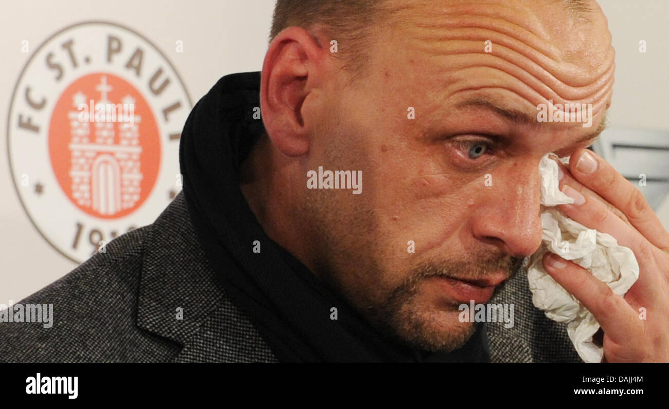 Coach Holger Stanislawski dries his eyes on a press conference in Hamburg, Germany, 13 April 2011. He is going to leave the Bundesliga football team FC St. Pauli at the end of the season. PHOTO: ANGELIKA WARMUTH Stock Photo