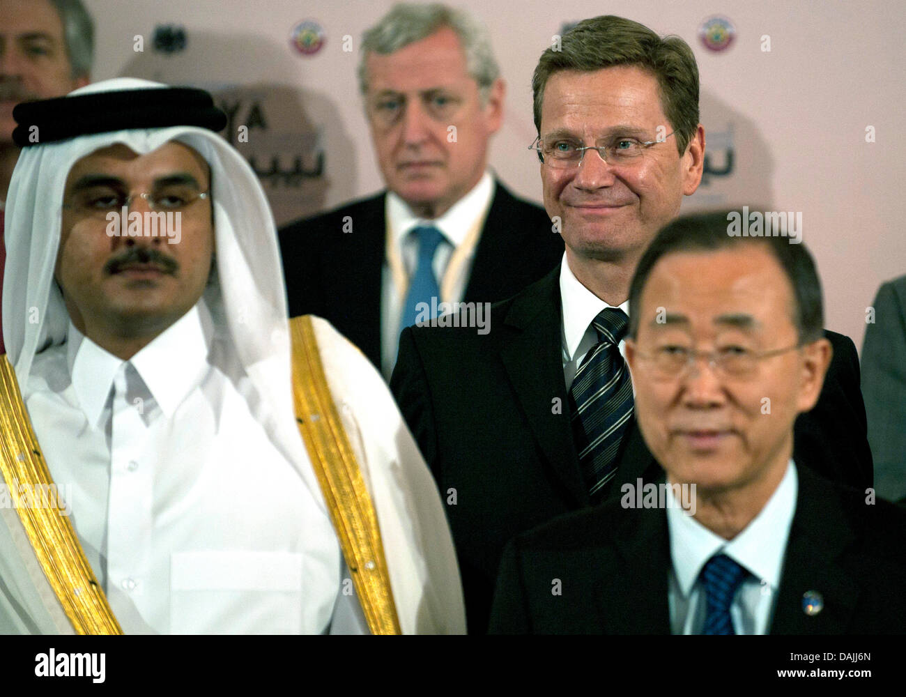 The Foreign Ministers (L-R) of Qater, Sheik Hamad bin Jassim bin Jabor Al Thani, Guido Westerwelle of Germany and UN Secretary General Ban Ki-Moon (and a person not identified in the background) take part in a meeting of the Libya Contact Group in Doha, Qatar, 13 April 2011. The politicians intend to negotiate further political proceedings in Libya. Photo: Peer Grimm Stock Photo