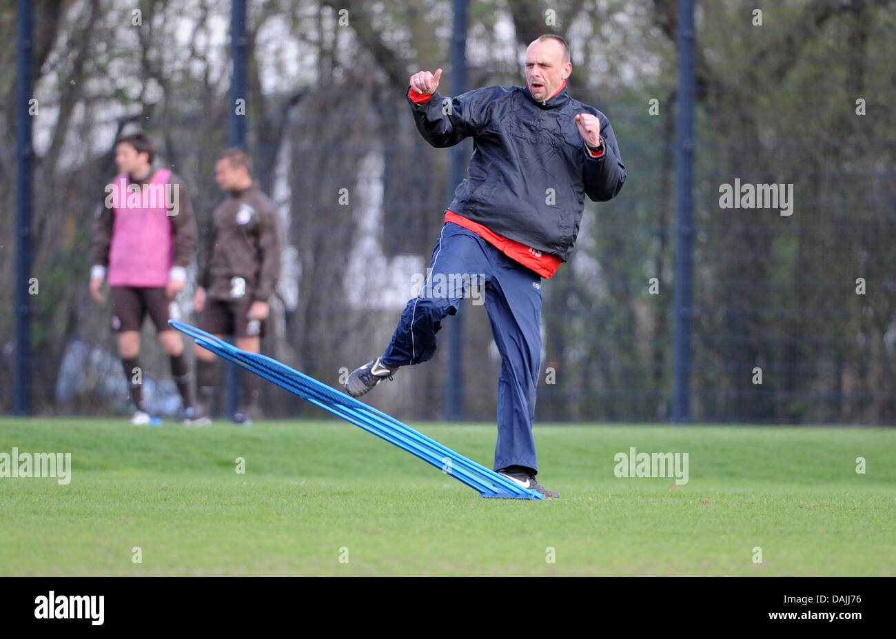 Coach Holger Stanislawski kicks a dummy at the training ground in Hamburg, Germany, 13 April 2011. He is going to leave the Bundesliga football team FC St. Pauli at the end of the season. PHOTO: ANGELIKA WARMUTH Stock Photo