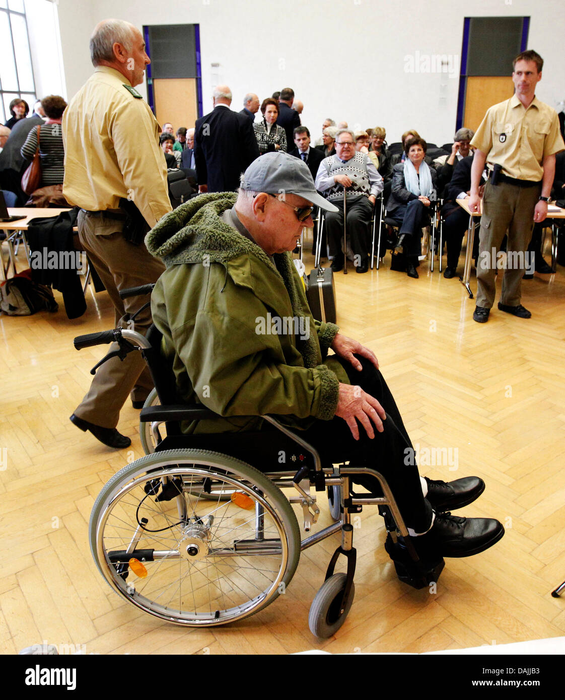 Former concentration camp prisoner/guard (KAPO) John Demjanjuk stands trial in a wheelchair at the state court in Munich, Germany, 14 April 2011. Demjanjuk is charged with 27,900 counts of acting as an accessory to murder, one for each person who died at Sobibor during the time he is accused of serving as a guard at the Nazi death camp. Photo: SEBASTIAN WIDMANN Stock Photo