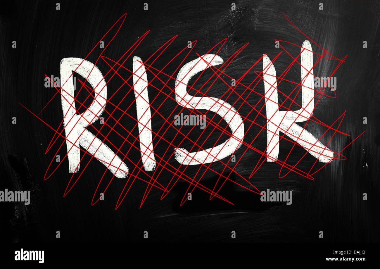 Risk handwritten with white chalk on a blackboard Stock Photo - Alamy