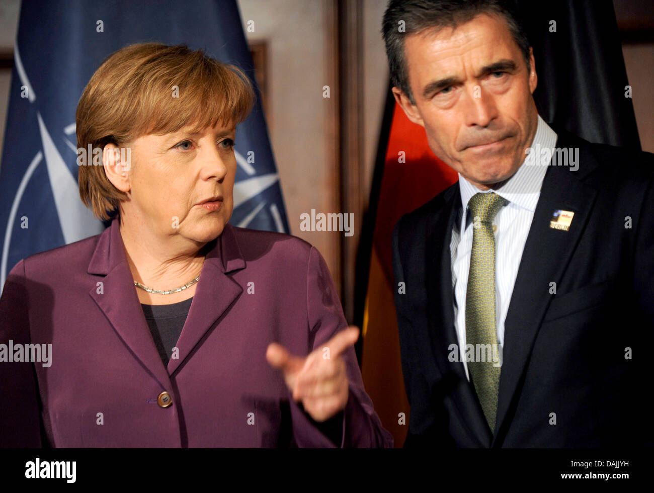 NATO General Secretary Anders Fogh Rasmussen (r) talks with German Chancellor Angela Merkel during a reception at the meeting of the Nato Foreign Ministers in Berlin, Germany, 14 April 2011. The Foreign Ministers of the Nato met in Berlin to discuss their further actions in the Libya conflict. Photo: Berthold Stadler Stock Photo