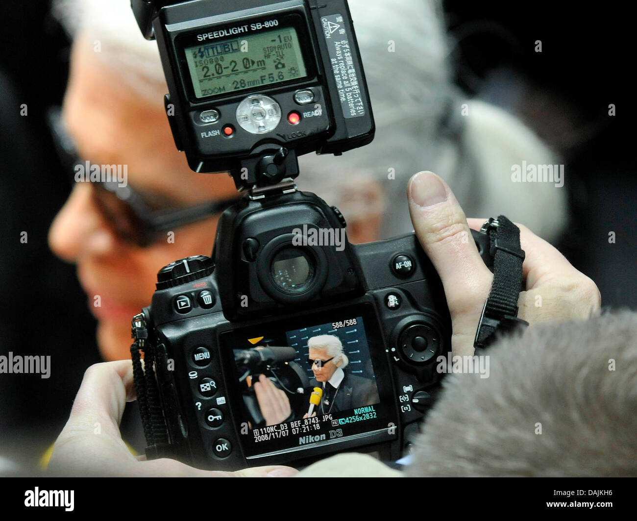 German fashion designer Karl Lagerfeld poses and is captured by a  photographer during the opening party for his 'Schwarzkopf Lightbox by Karl  Lagerfeld' in Duesseldorf, Germany, 14 April 2011. The lightbox that