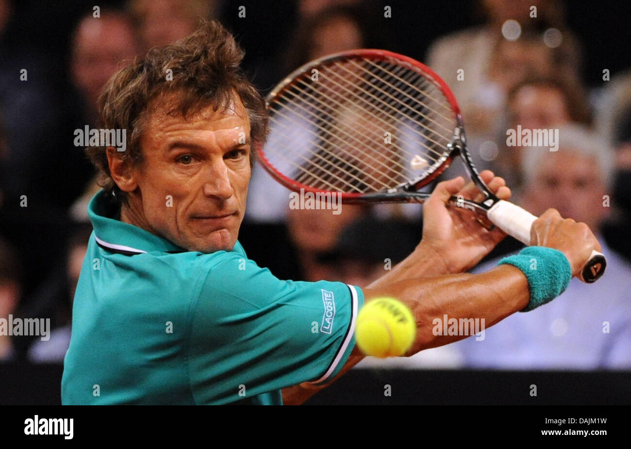 The former professional tennis player Mats Wilander plays a backhand during a show match against