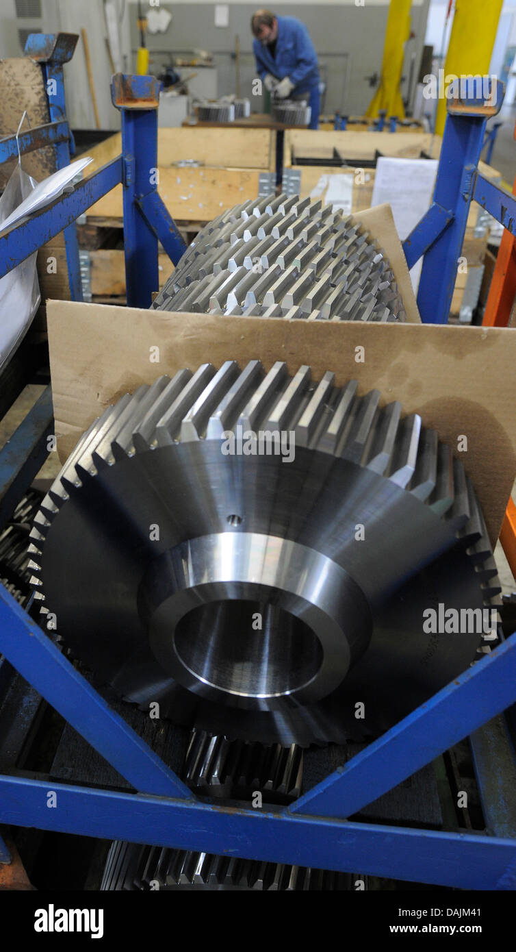 A member of staff trimms a spur gear at the manufacturing plant in