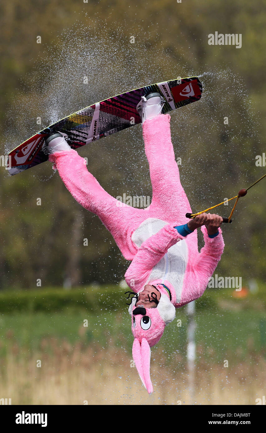 Waterskier Rick Jensen rides his board in a pink rabbit's costume at ...