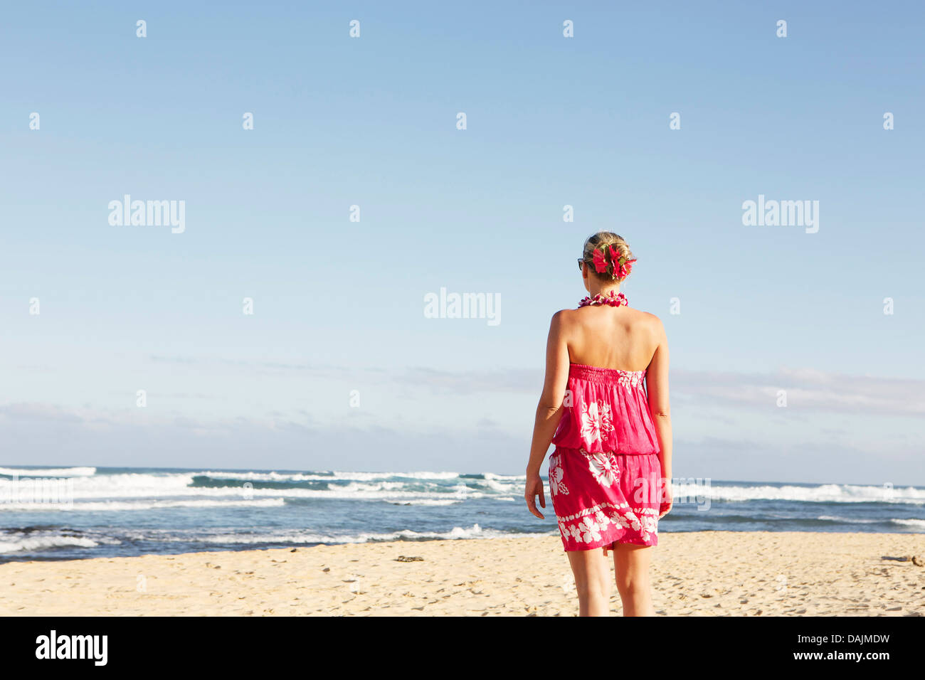 USA, Hawaii, Mid adult woman standing on beach Stock Photo - Alamy