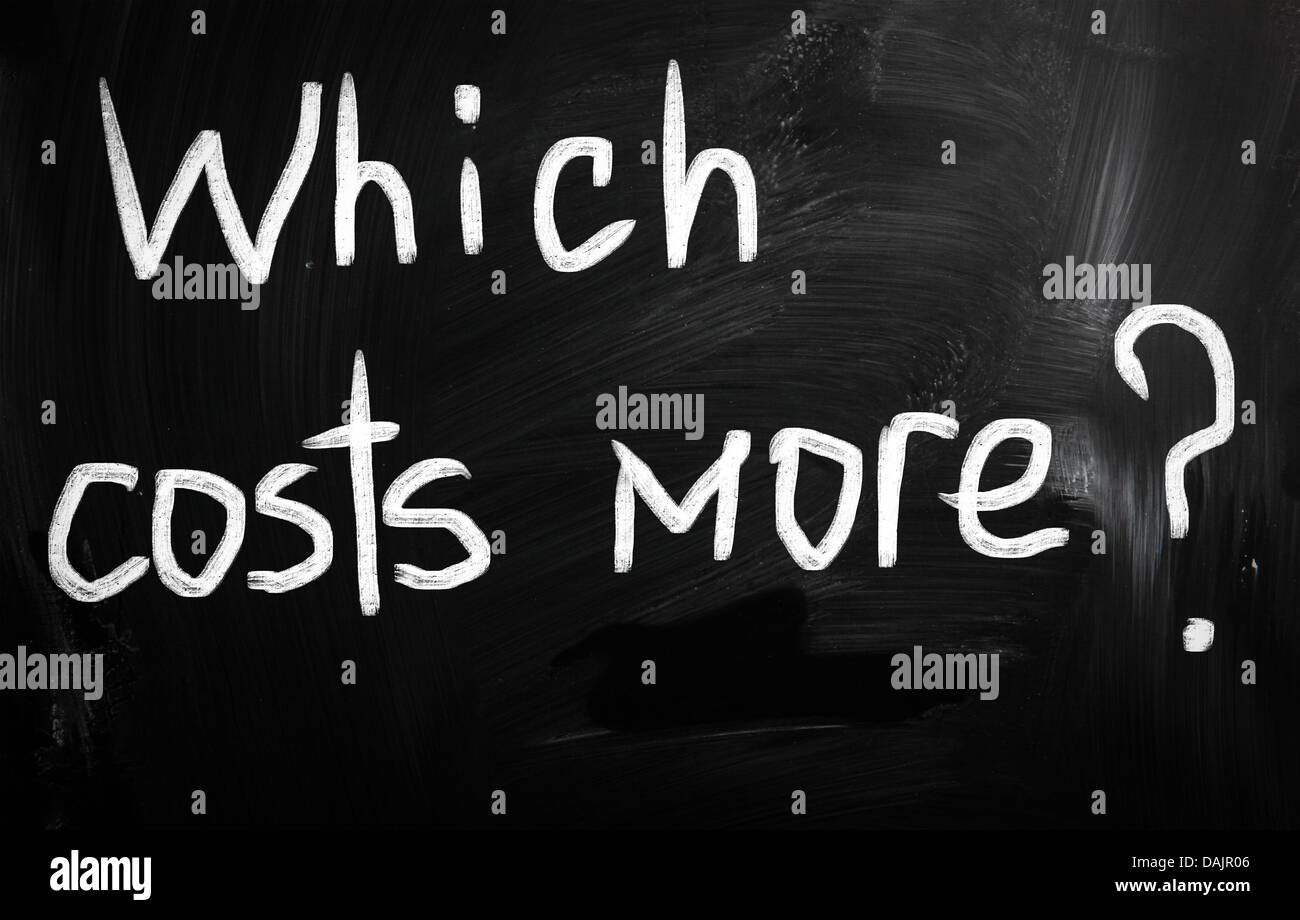 Which costs more? handwritten with white chalk on a blackboard Stock