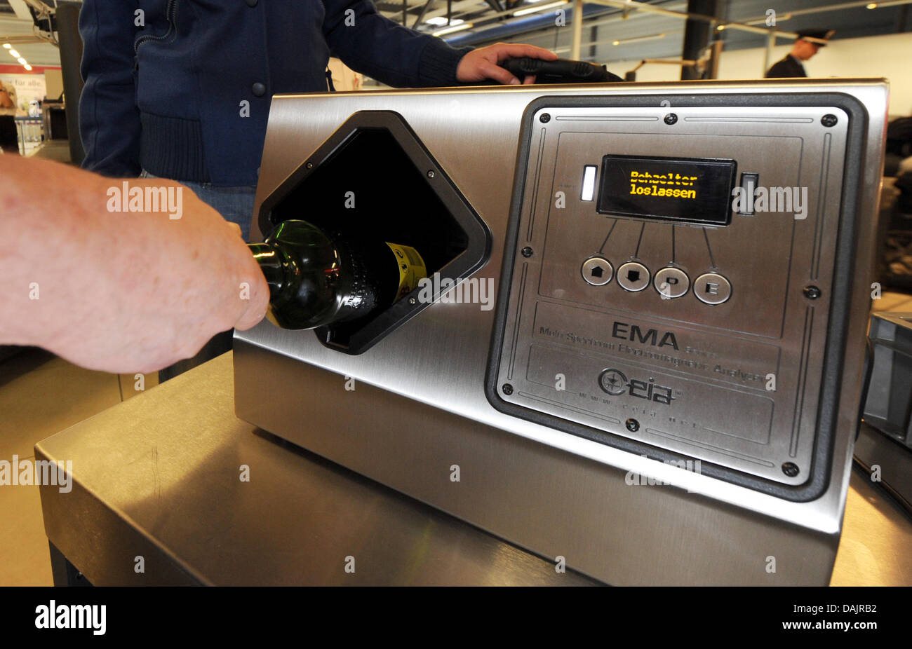 Police officers present a new scanner for liquids at the airport in  Schoenefeld, Germany, 27 April 2011. Due to the introduciton of this device  into the airport system, passangers are allowed to