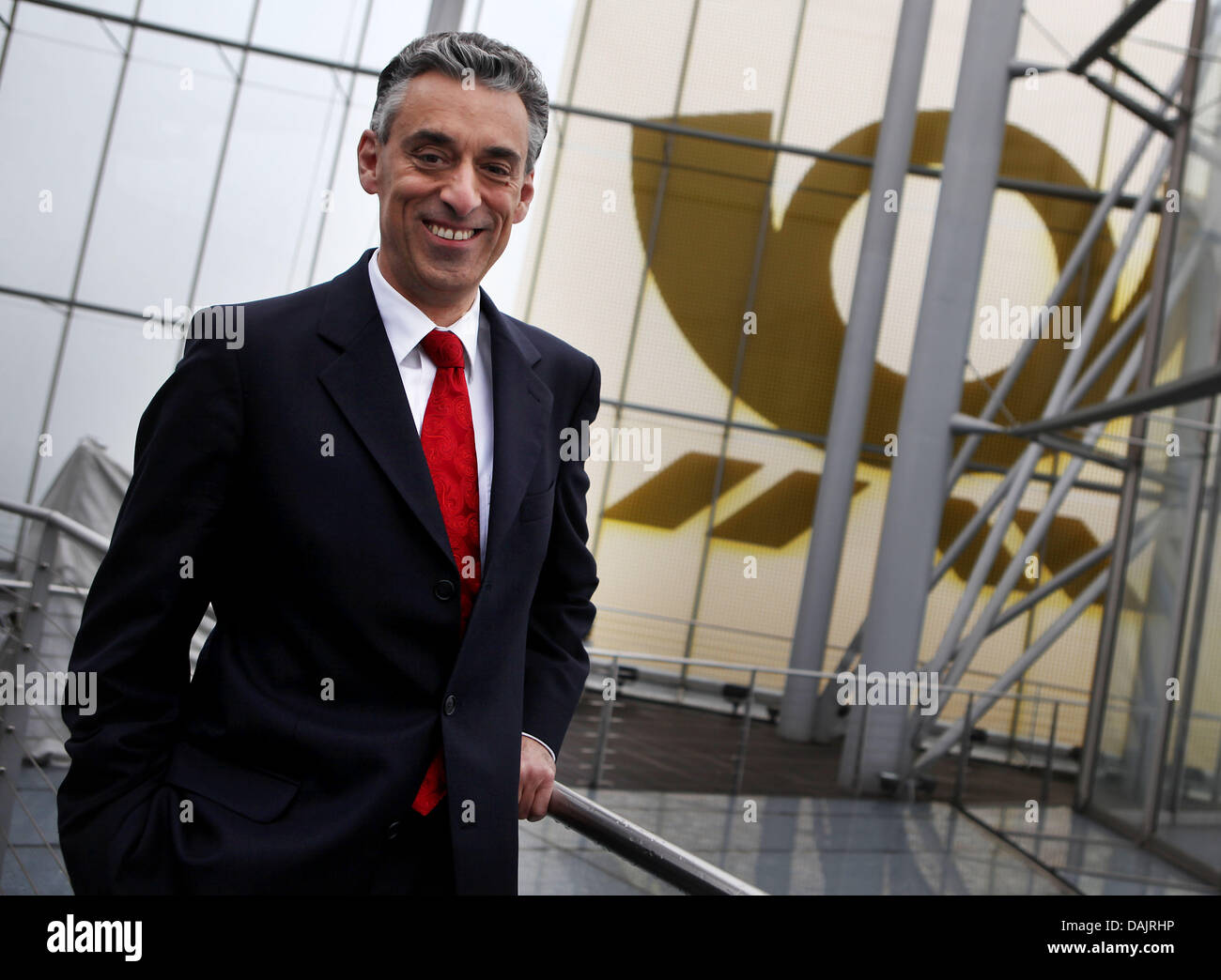 Deutsche Post and DHL CEO Frank Appel stands on the Post Tower in front of the Deutsche Post logo in Bonn, Germany, 27 April 2011. Photo: Oliver Berg Stock Photo