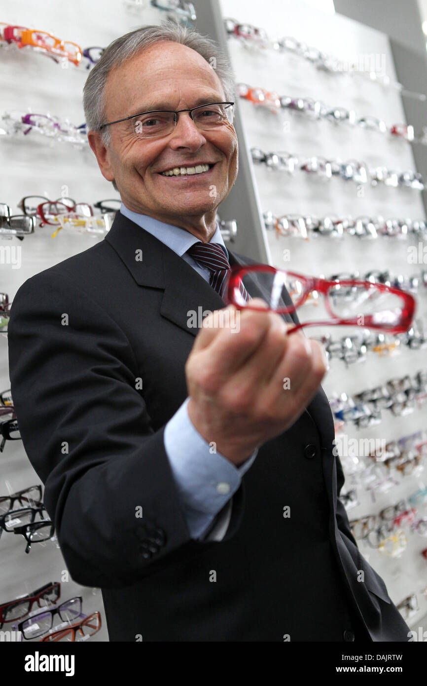 CEO of Fieldmann AG, Guenther Fielmann poses with glasses after a press