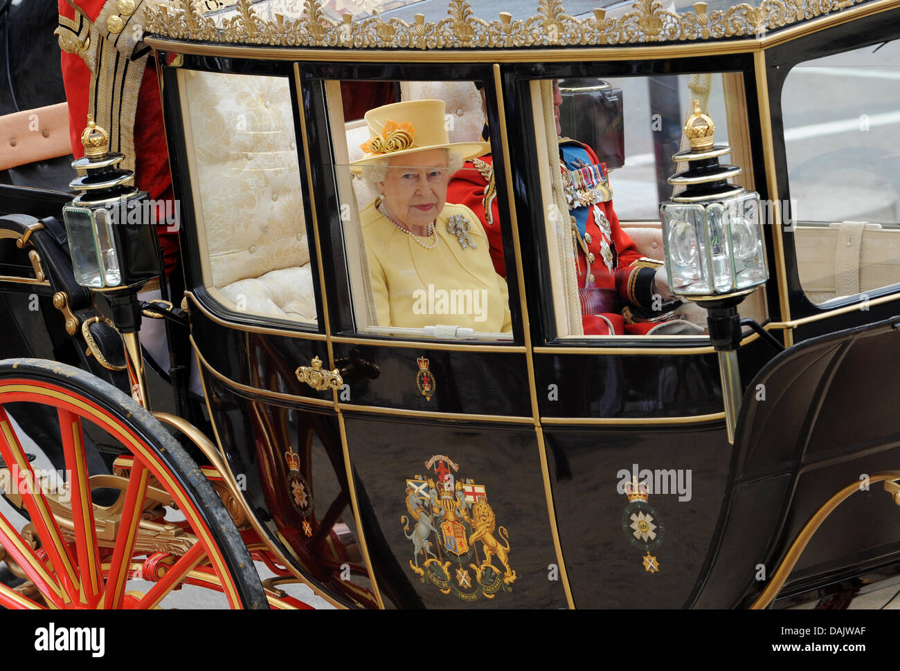British Queen Elizabeth II rides in a horsedrawn carriage from Westminster Abbey to Buckingham