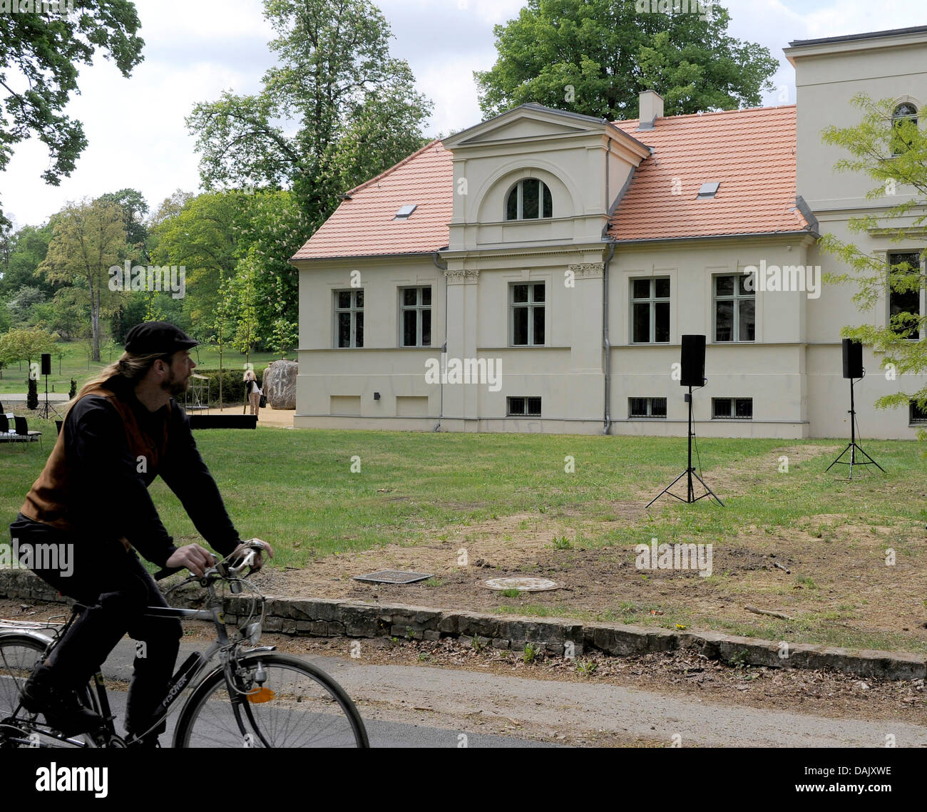 A cyclist rides past Lespsius Haus in Potsdam, Germany, 02 May 2011. In the research and meeting center, there is an exhibition about the work of theologist and orientalist Johannes Lepsius (1858-1926), who campaigned heavily for persecuted Armenians. There have been protest from Turkey against the memorial. Photo: BERND SETTNIK Stock Photo