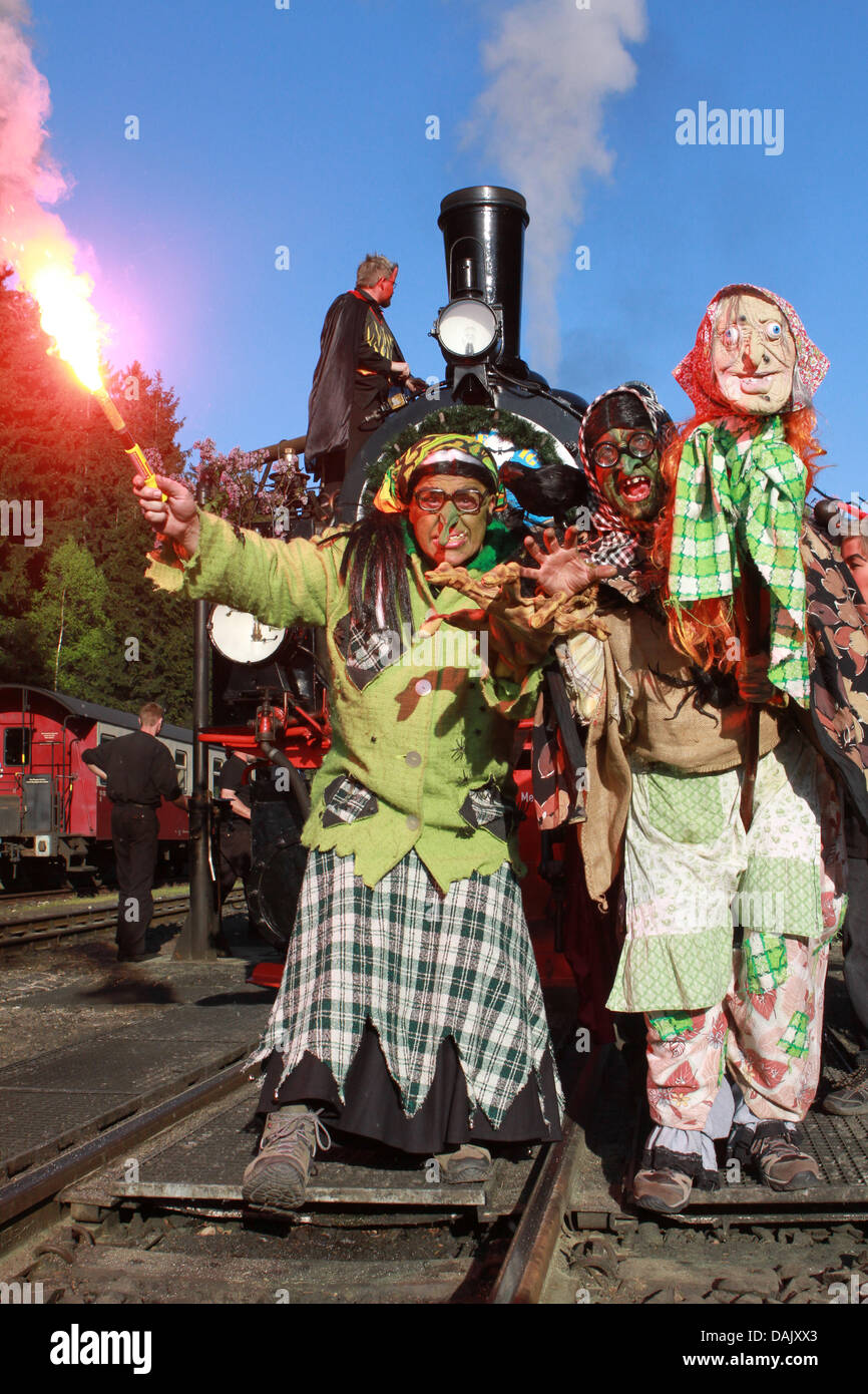 Costumed guests to the Walpurgis festival stand in front of a light railway train in Schierke, Germany, 20 April 2011. The night of 30 April is famous worldwide, because of Johann Wolfgang Goethe's classic 'Faust', where he describes how witches ride around brooms or billy goats to have orgies with the devil. Photo: Matthias Bein Stock Photo