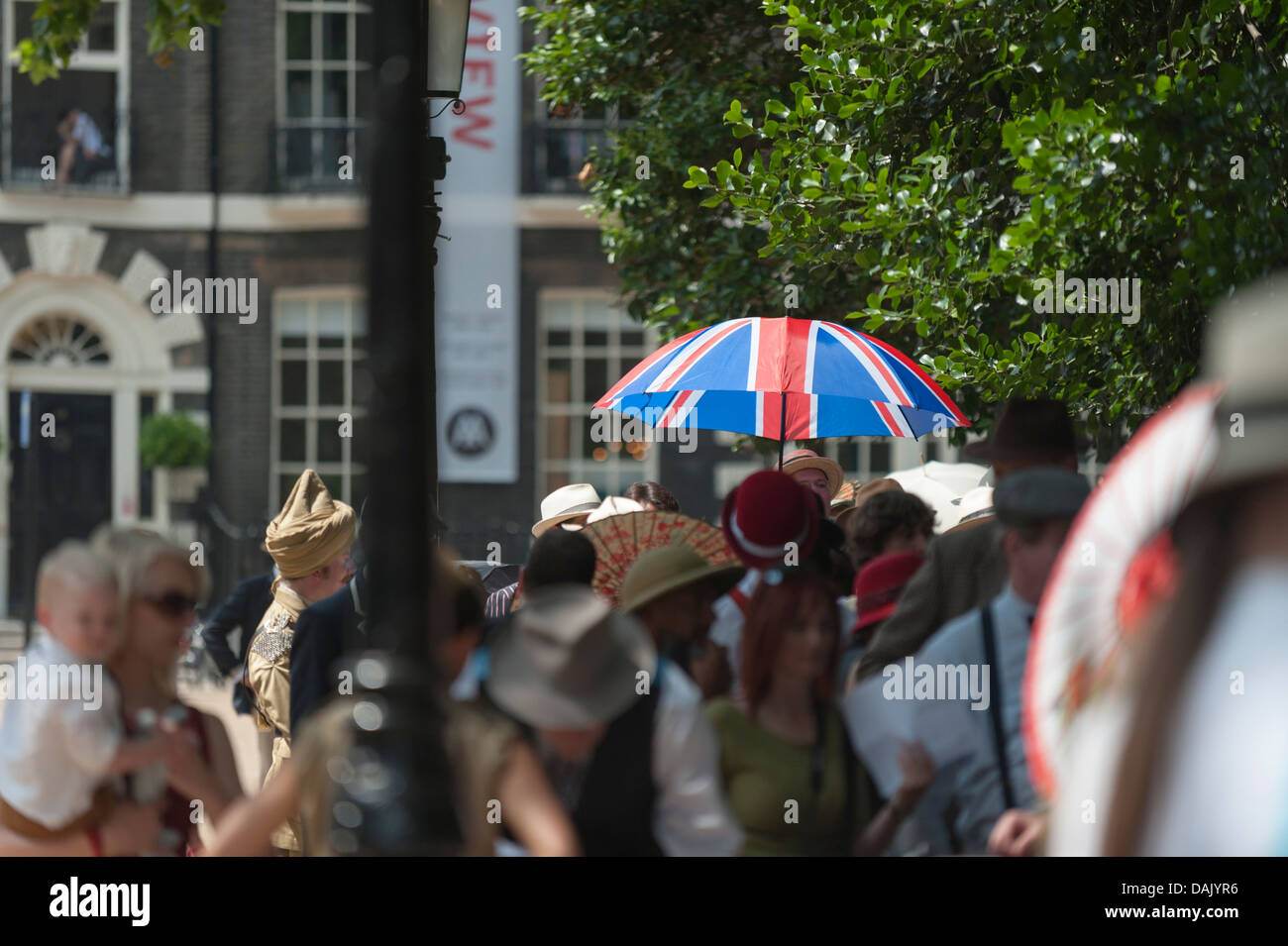 A Union Flag umbrella held in the queue of people waiting to enter Bedford Square Gardens for the start of the Chaps Olympiad. Stock Photo