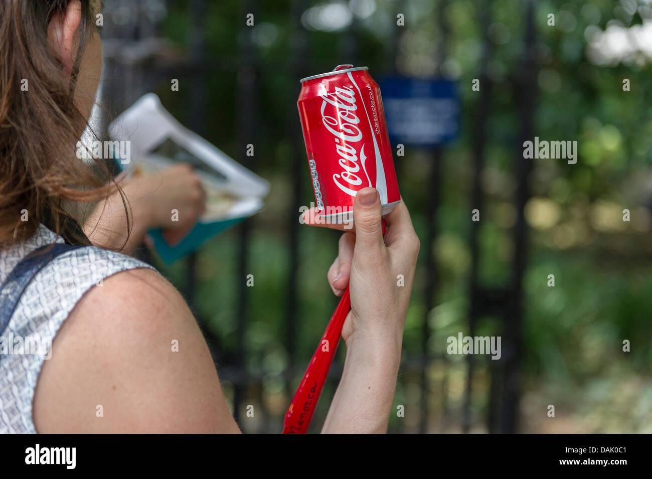 A can of Coca Cola held by a girl. Stock Photo