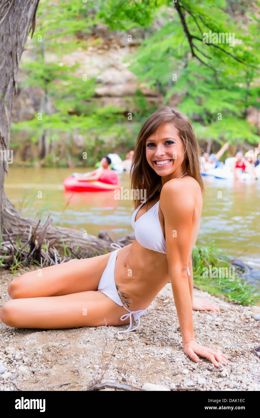 USA, Texas, Young woman in bikini at the Frio River with people tubing the  river in the background Stock Photo - Alamy