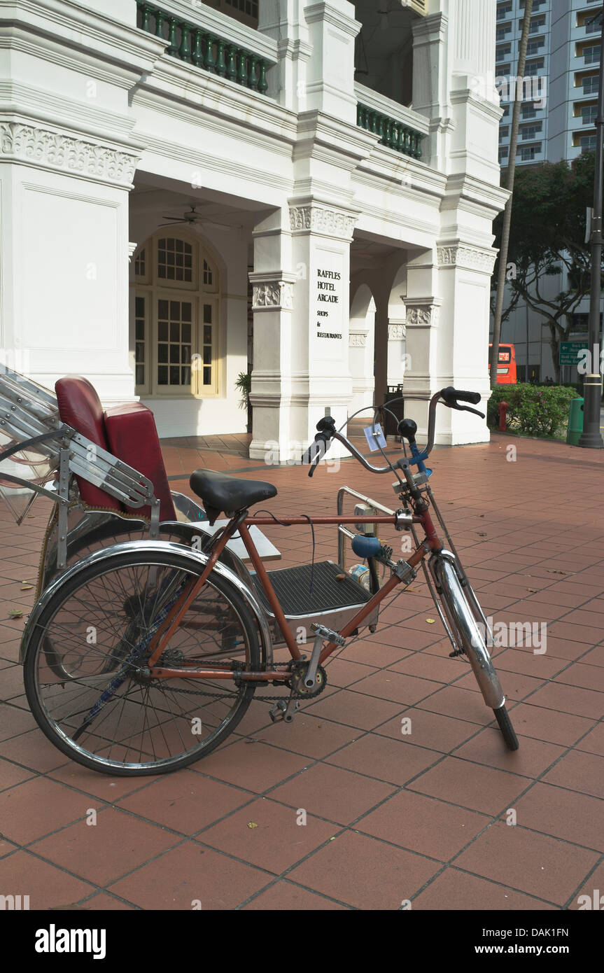 dh  RAFFLES HOTEL SINGAPORE Rickshaw bike outside Raffles hotel building Stock Photo