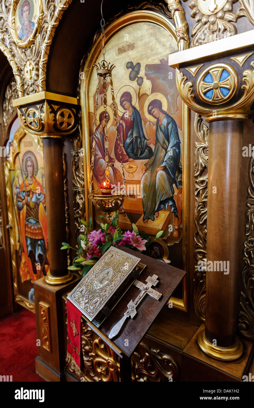 Part of iconostasis with Holy Trinity icon and Holy Cross and Bible in ...