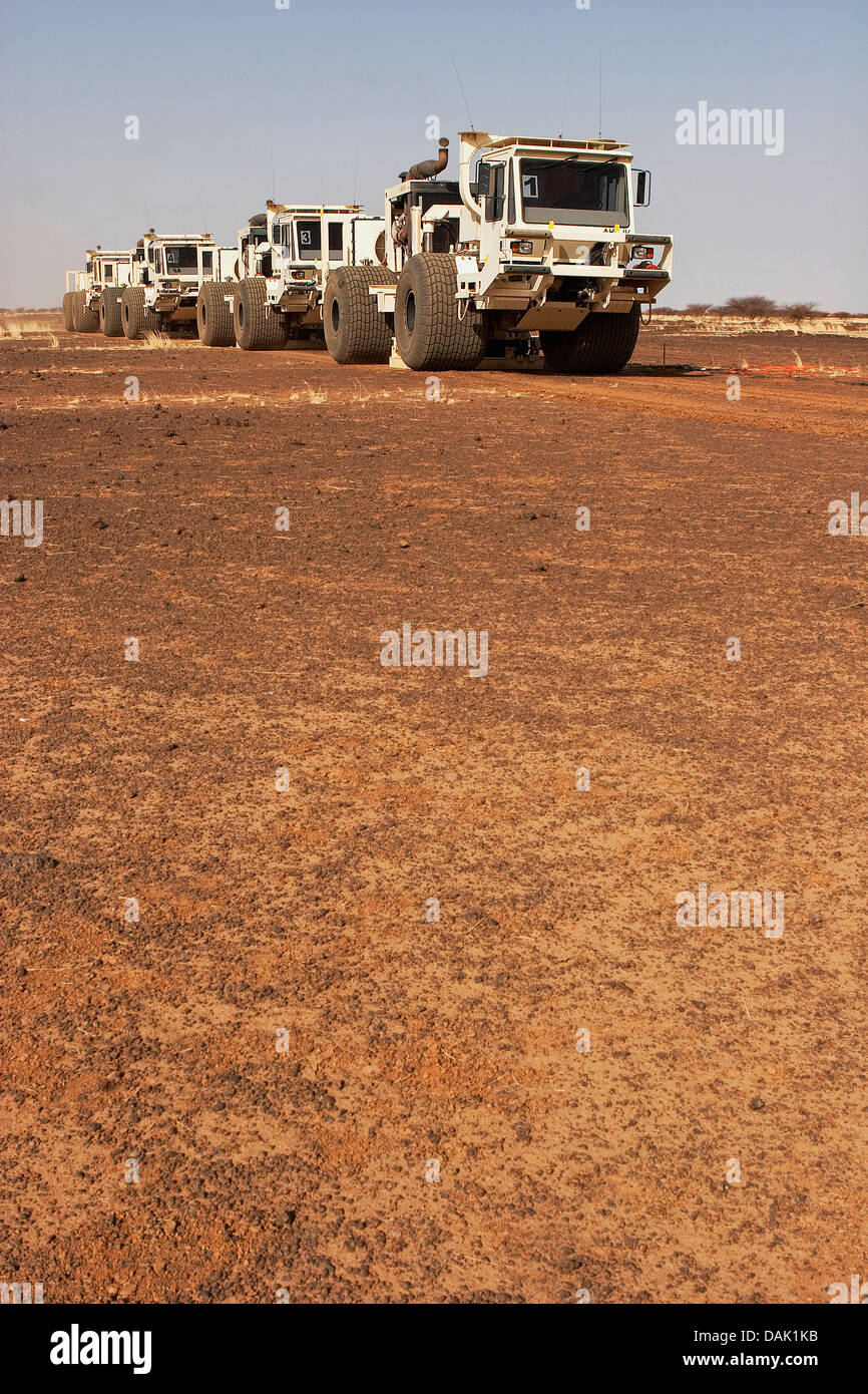 Oil exploration Mali. Seismic vibrator vehicles moving across desert