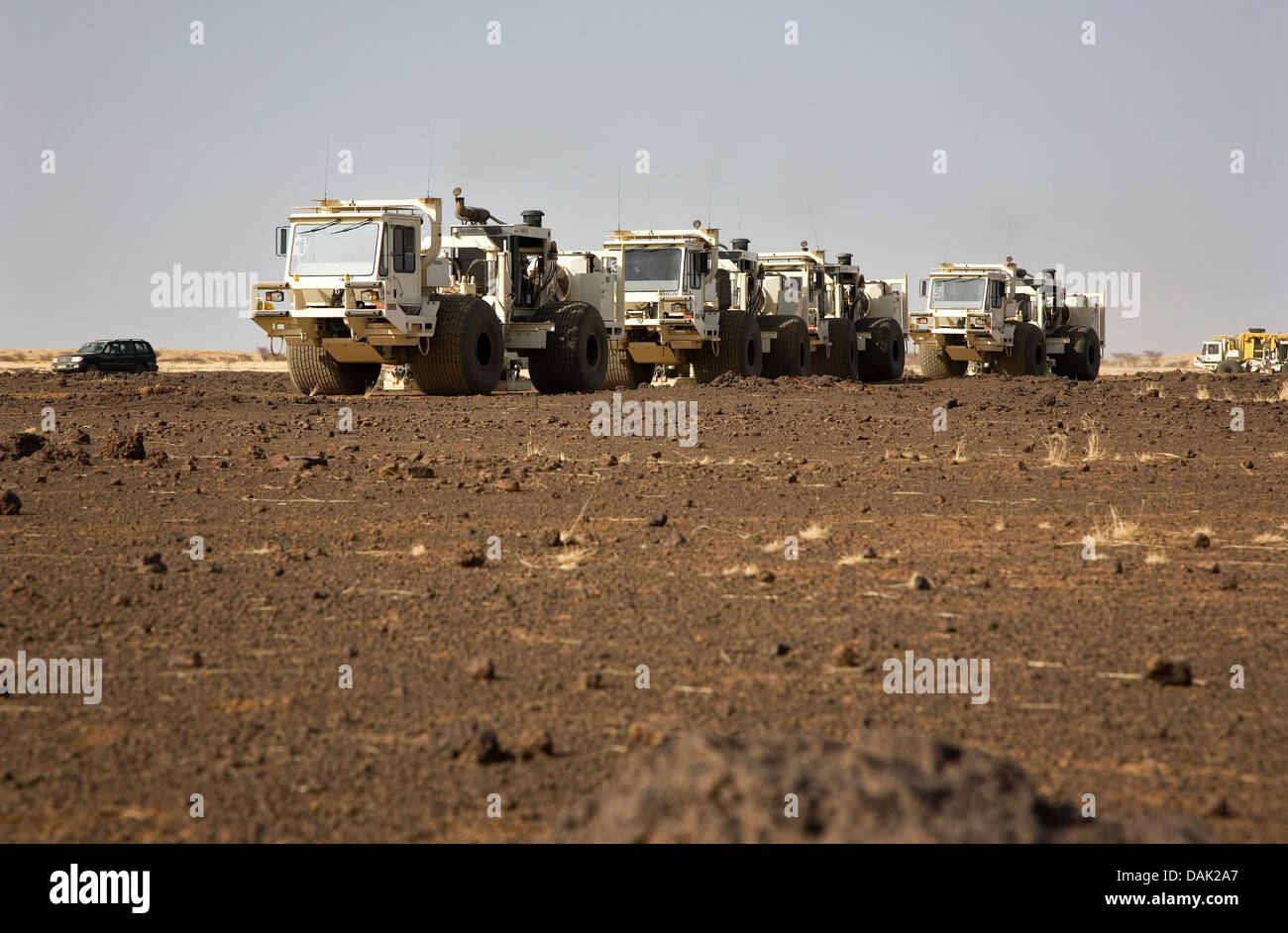 Oil exploration Mali. Seismic vibrator vehicles moving across desert and scrub terrain on geophysical survey of concession. Stock Photo