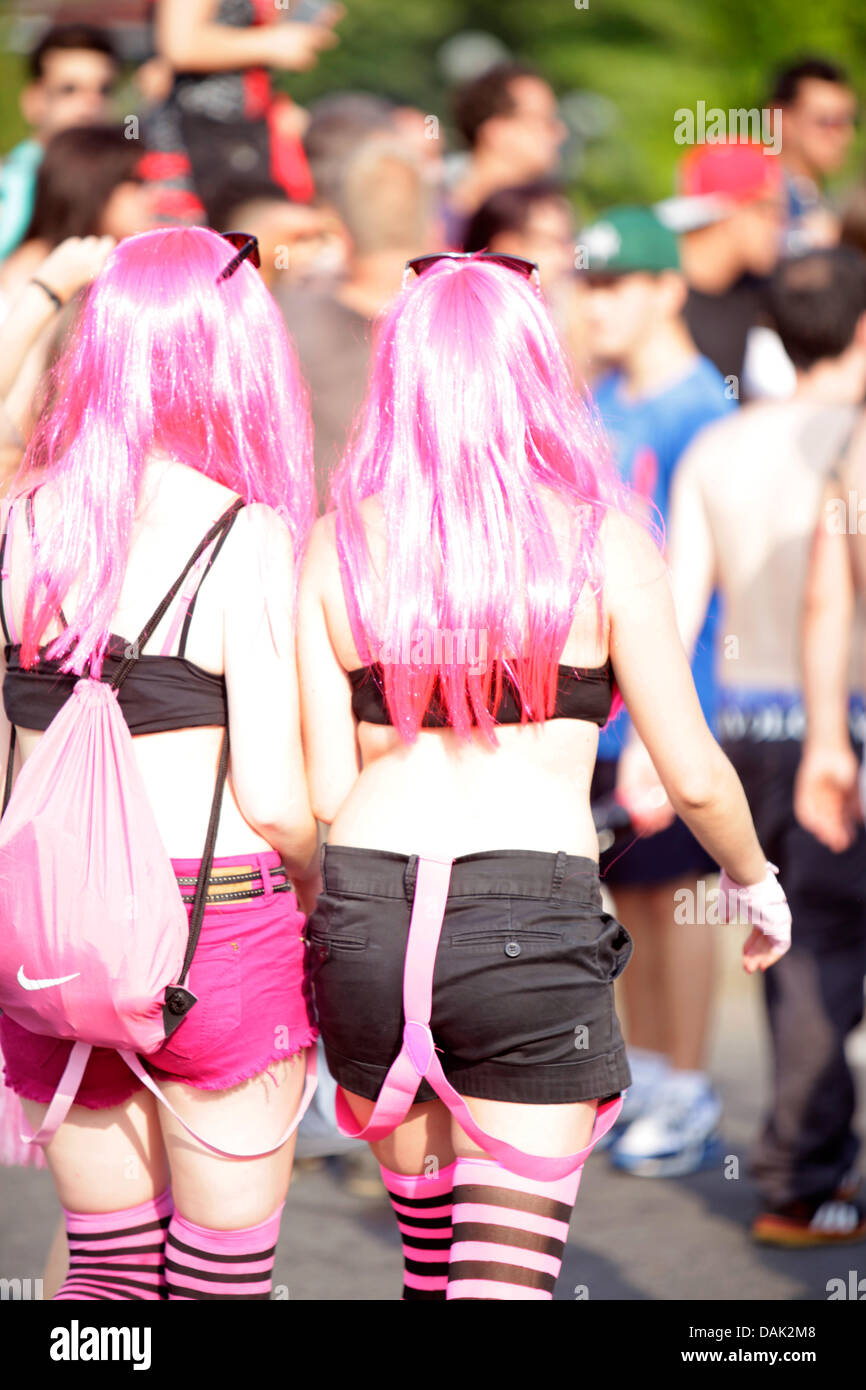 Two young girls in pink wigs enjoying the Lake Parade street event in Geneva, Switzerland. Participants expressing fun, freedom, love, enjoyment, happyness. Credit:  ImageNature, Alexander Belokurov / Alamy Stock Photo