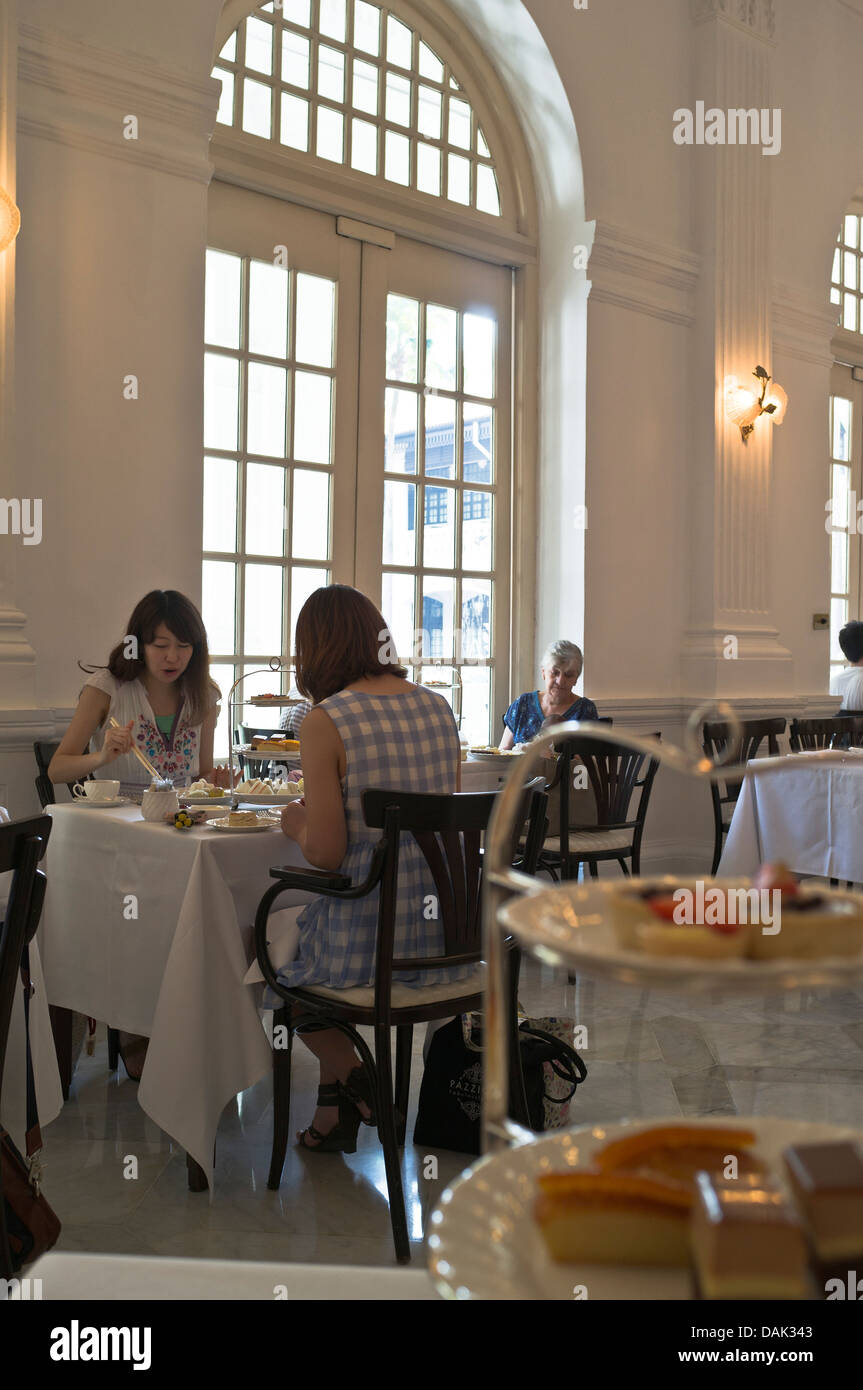 dh Tiffin Room interior RAFFLES HOTEL SINGAPORE Asian tourism Japanese girl tourists having afternoon high tea people eating Stock Photo