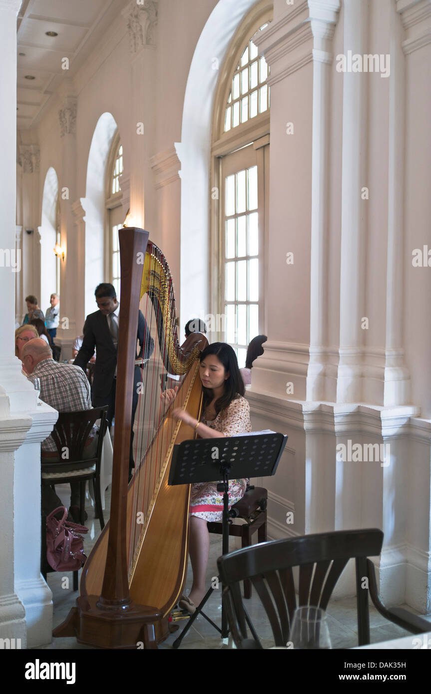 dh Tiffin Room RAFFLES HOTEL SINGAPORE Harpist playing to afternoon tea customers harp player interior Stock Photo