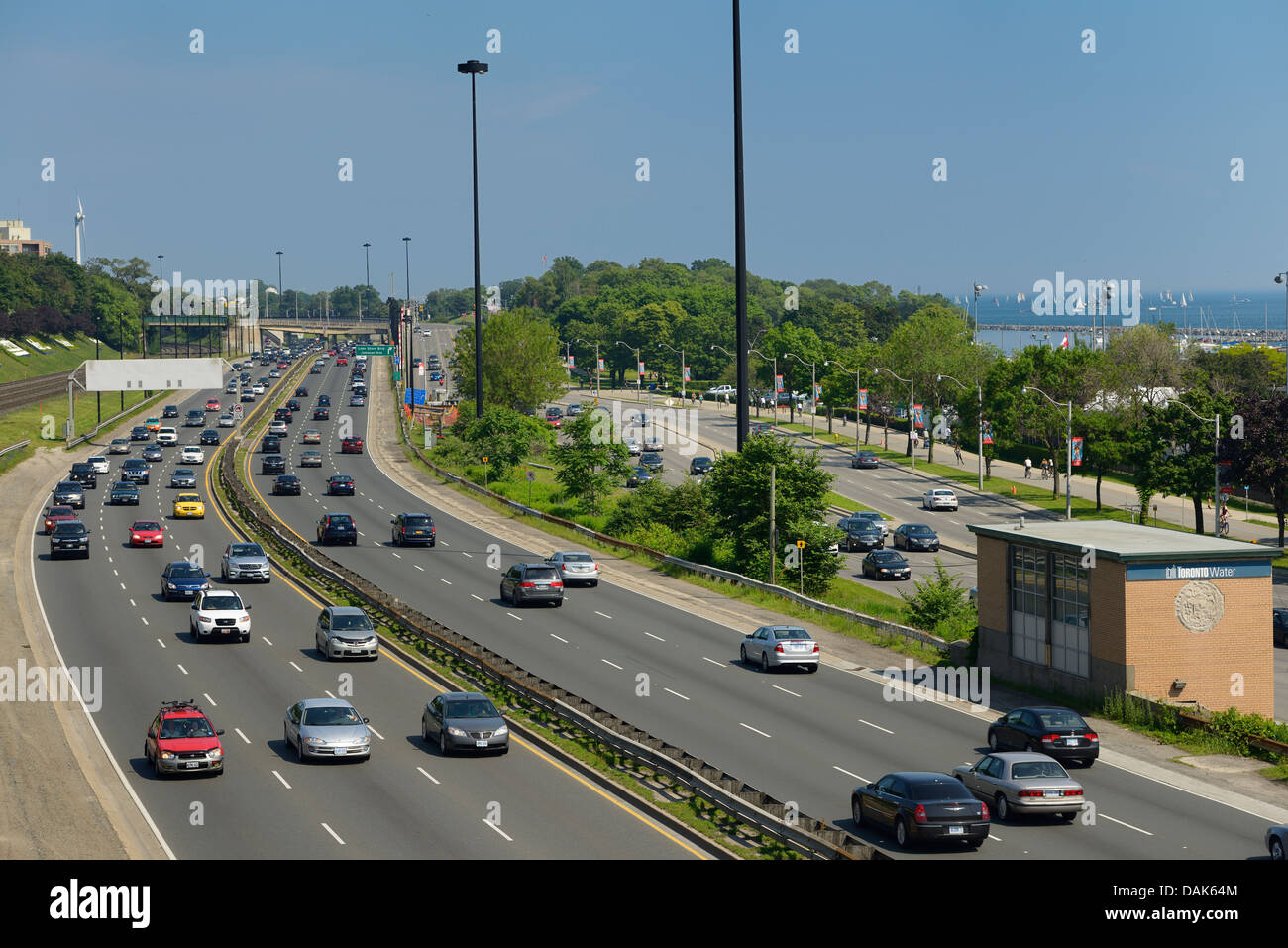 Toronto Sunday traffic on the Gardiner Expressway with tall ships in the Harbour Stock Photo