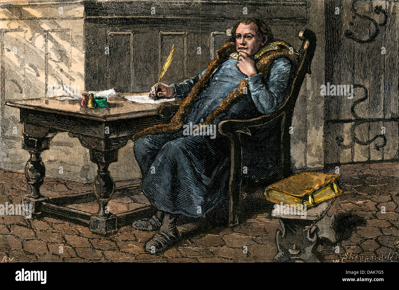 Martin Luther at his desk. Hand-colored woodcut Stock Photo