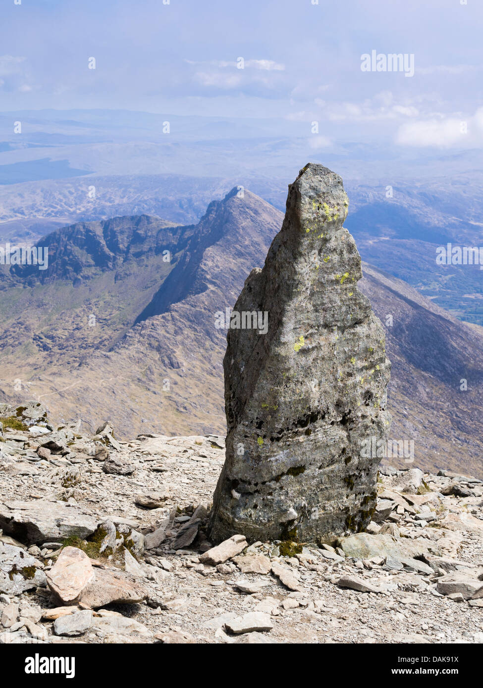 Stone marker at top of Watkin path on Mt Snowdon with view to Y Lliwedd in Snowdon horseshoe in mountains of Snowdonia Wales UK Stock Photo