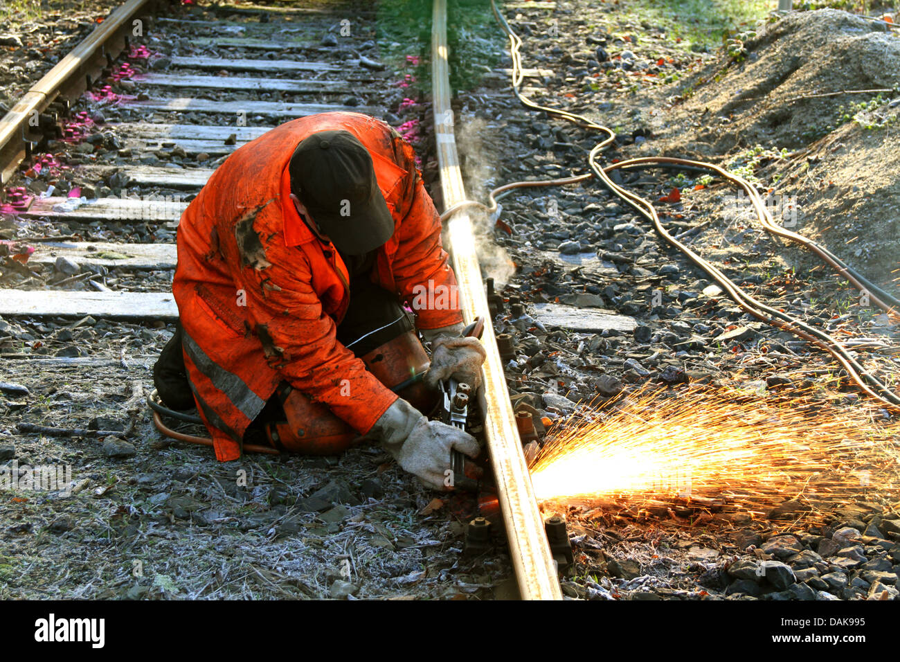 railway worker cutting with blowpipe a railway track, Germany Stock Photo