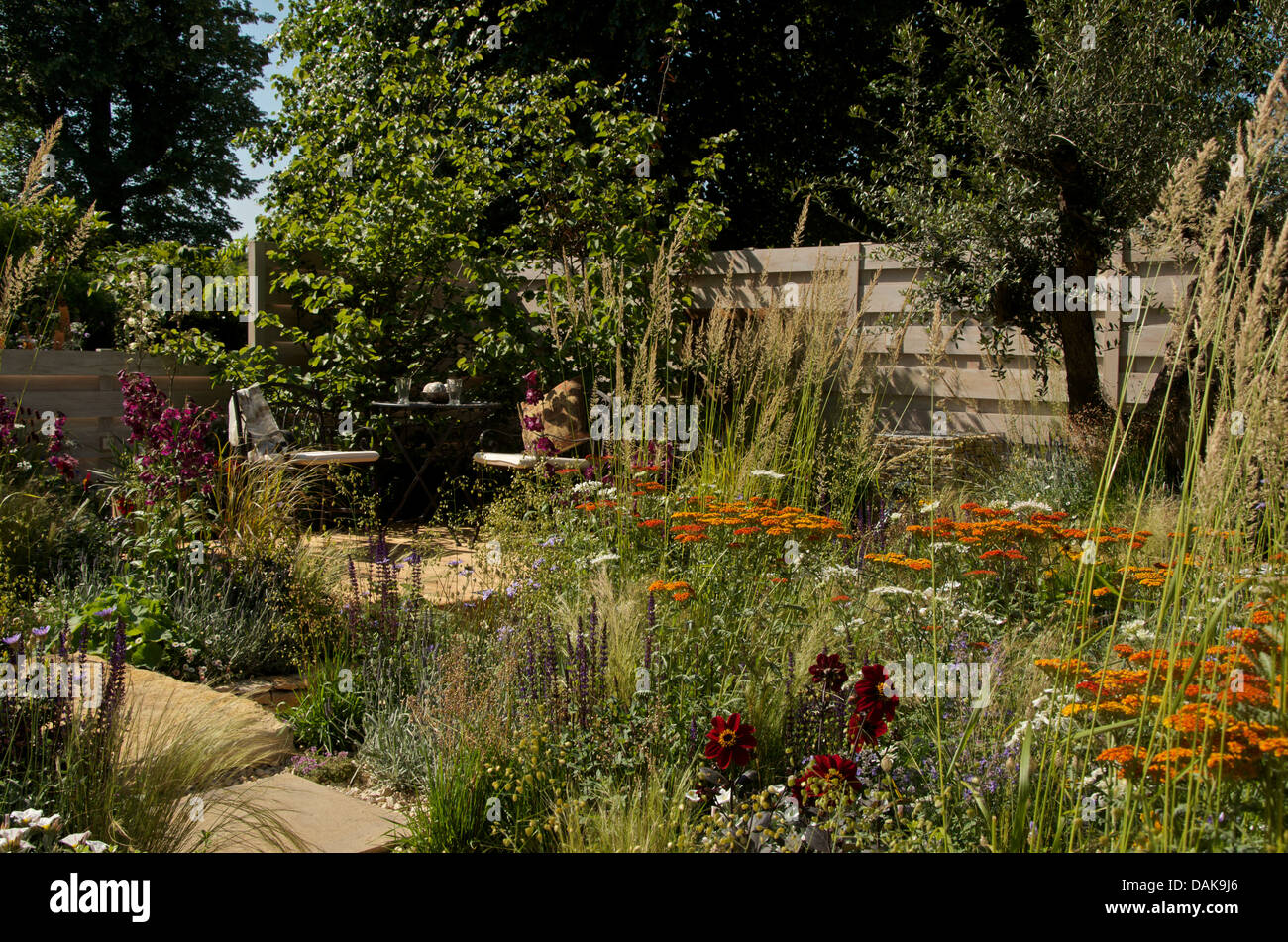 View of planting and seating area in The Four Corners Garden at RHS Hampton Court Palace Flower Show 2013. Stock Photo