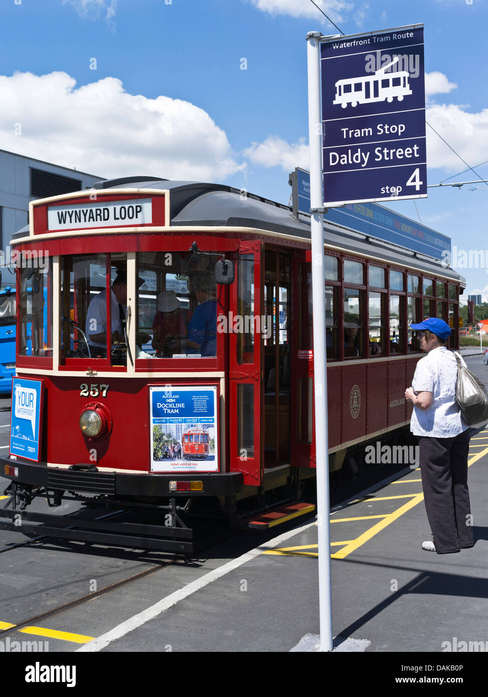 dh Wynyard Loop Trams AUCKLAND HARBOUR NEW ZEALAND NZ Passenger woman at street tram stop harbor quarter person people transport Stock Photo