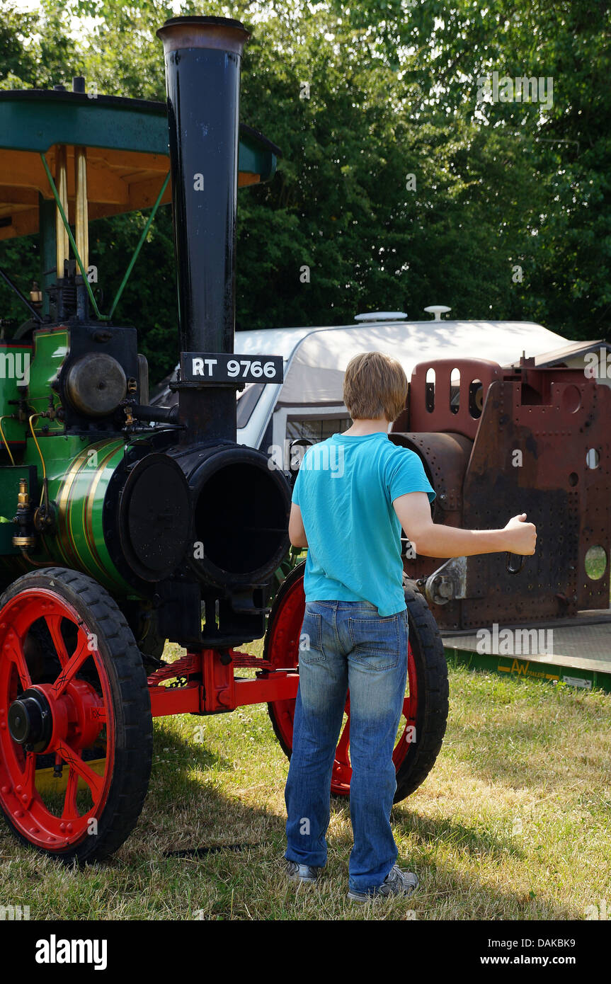 Male cleaning vintage steam engine at a show Stock Photo - Alamy