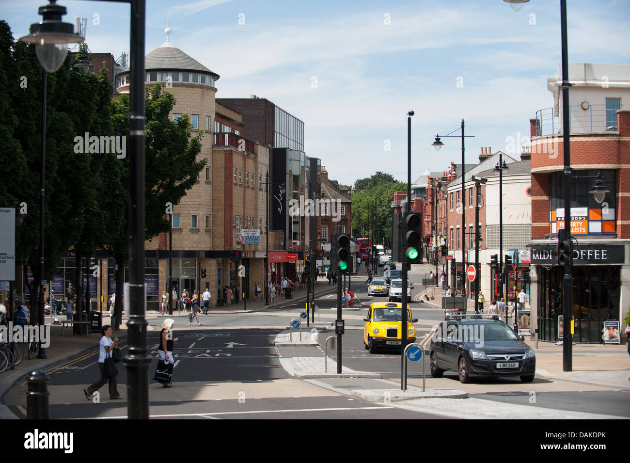 Street scene in Wimbledon Town Centre with shops and traffic at the