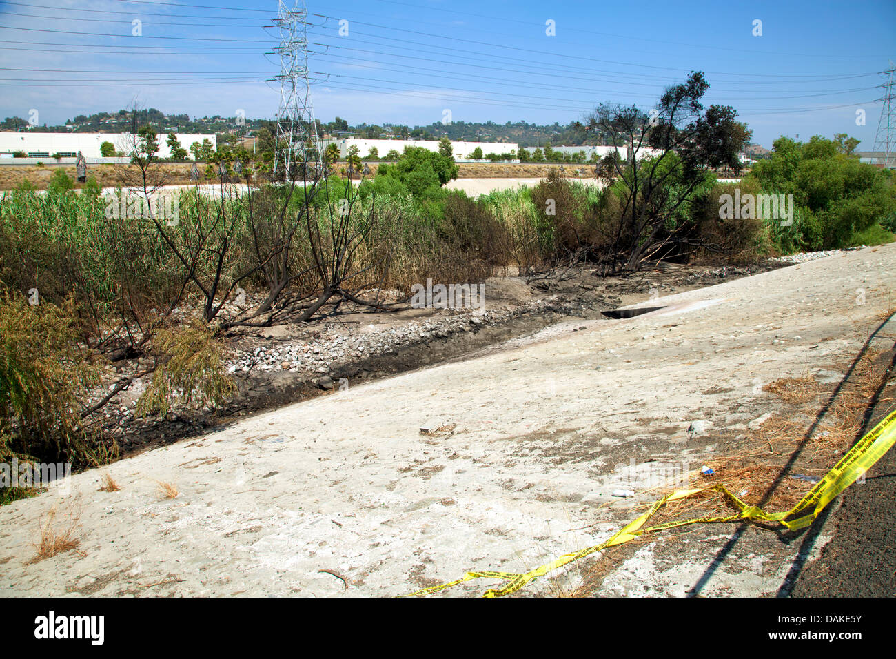 Los Angeles, USA. 13th July, 2013. Fire damage to Los Angeles River the day  after a tanker truck overturned on the nearby Interstate 5 near Elysian Valley spilling some of its 8500 gallons of gasoline which ran down a storm drain to the river. The overpowering smell of gas forced authorites to block off access to the river for the several hundred feet around the damage, several agencies includinf LADF and the EPA will be monitoring the situaion. The area was just recently opened for recreational use, including kayaking andf fishing, for the first time in 80 years. Stock Photo