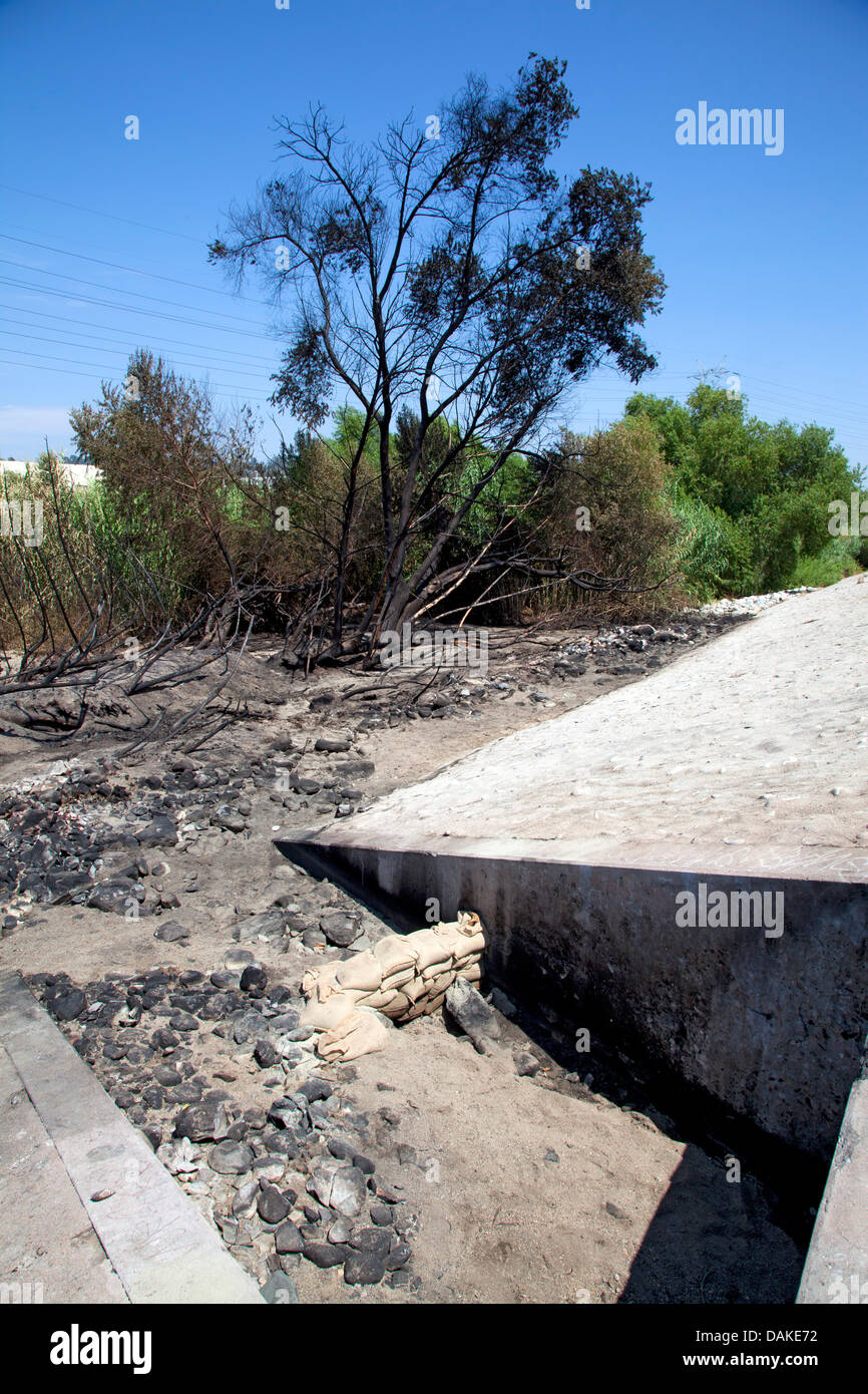 Los Angeles, USA. 13th July, 2013. Fire damage to Los Angeles River the day  after a tanker truck overturned on the nearby Interstate 5 near Elysian Valley spilling some of its 8500 gallons of gasoline which ran down a storm drain to the river. The overpowering smell of gas forced authorites to block off access to the river for the several hundred feet around the damage, several agencies includinf LADF and the EPA will be monitoring the situaion. The area was just recently opened for recreational use, including kayaking andf fishing, for the first time in 80 years. Stock Photo