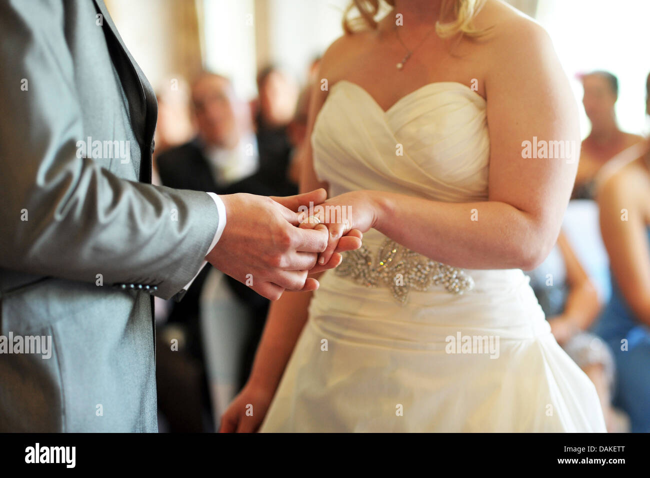 Bride and groom exchange wedding rings during the wedding ceremony. Stock Photo