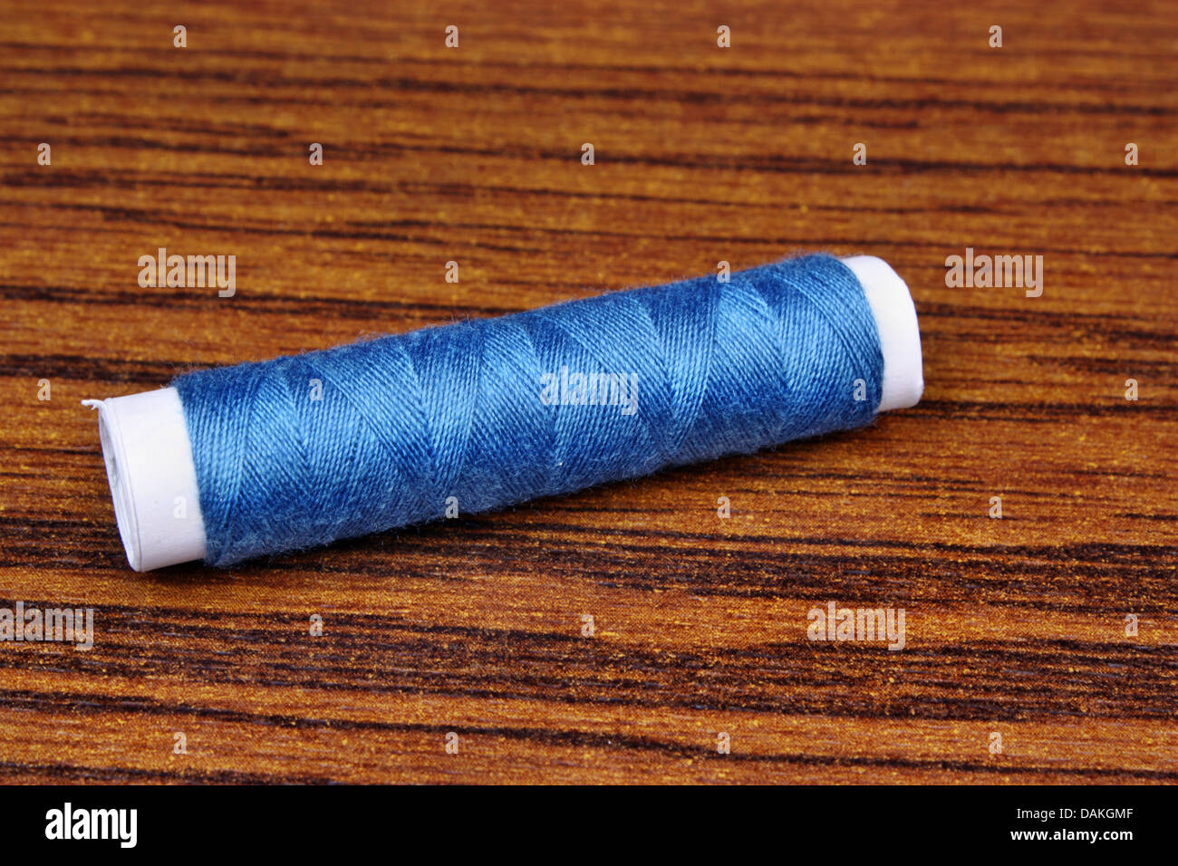 Blue sewing thread Stock Photo - Alamy